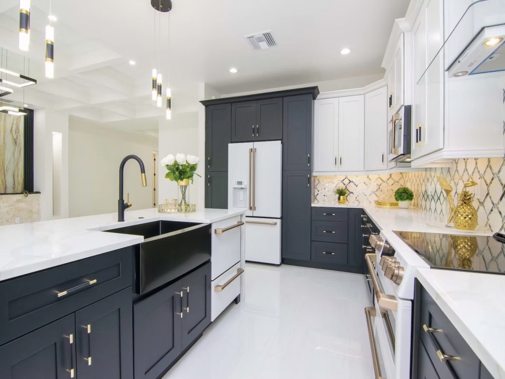 Elegant two-tone kitchen with navy lower cabinets, white uppers, and soft pendant lighting