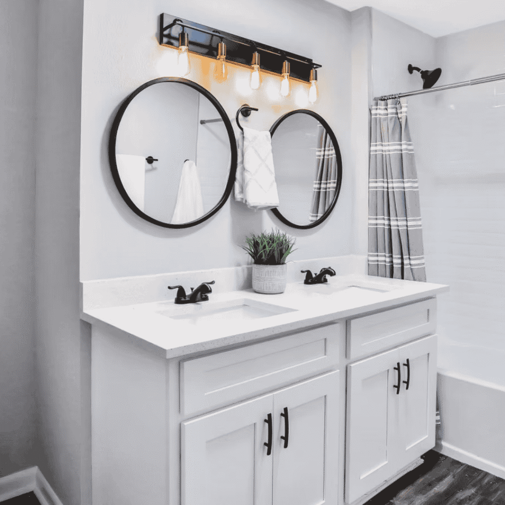 white bathroom cabinet with double vanity and circular mirrors